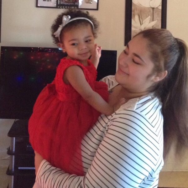 Woman holding a toddler.